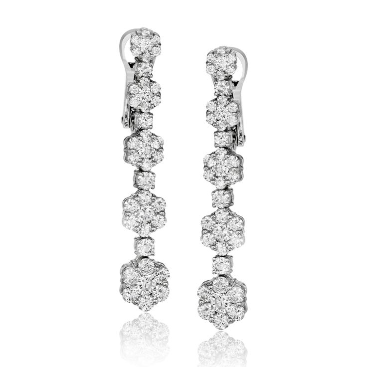 These lovely 18k white gold earrings feature a line of flowers set with 2.65 ctw...