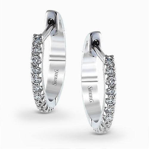 Featuring a classic hoop style with modern accents, these sparkling white gold e...