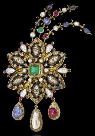 A 19th century gilt metal and multi gem-set ornamental brooch. In the style of a...