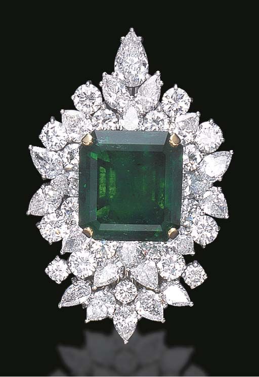 A SPECTACULAR EMERALD AND DIAMOND BROOCH  Centering upon a square-cut emerald, w...