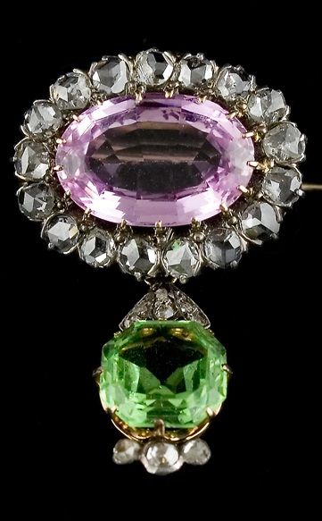 A Suffragette brooch, circa 1910. Surmounted by an oval pink topaz framed by dia...