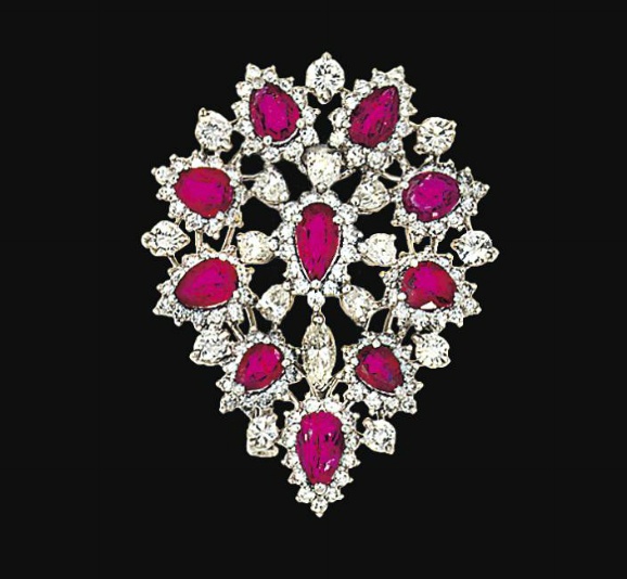 A ruby and diamond brooch   The pear-shaped ruby and brilliant-cut diamond clust...