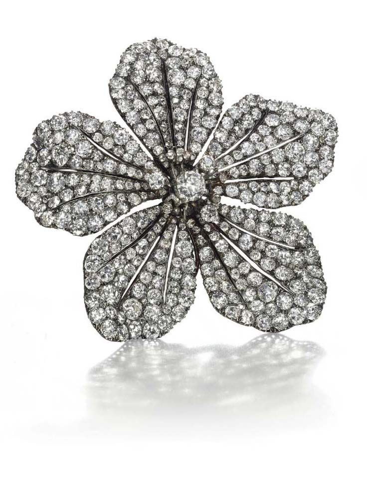 AN ANTIQUE DIAMOND FLOWER BROOCH. Designed as a five petal openwork flowerhead, ...