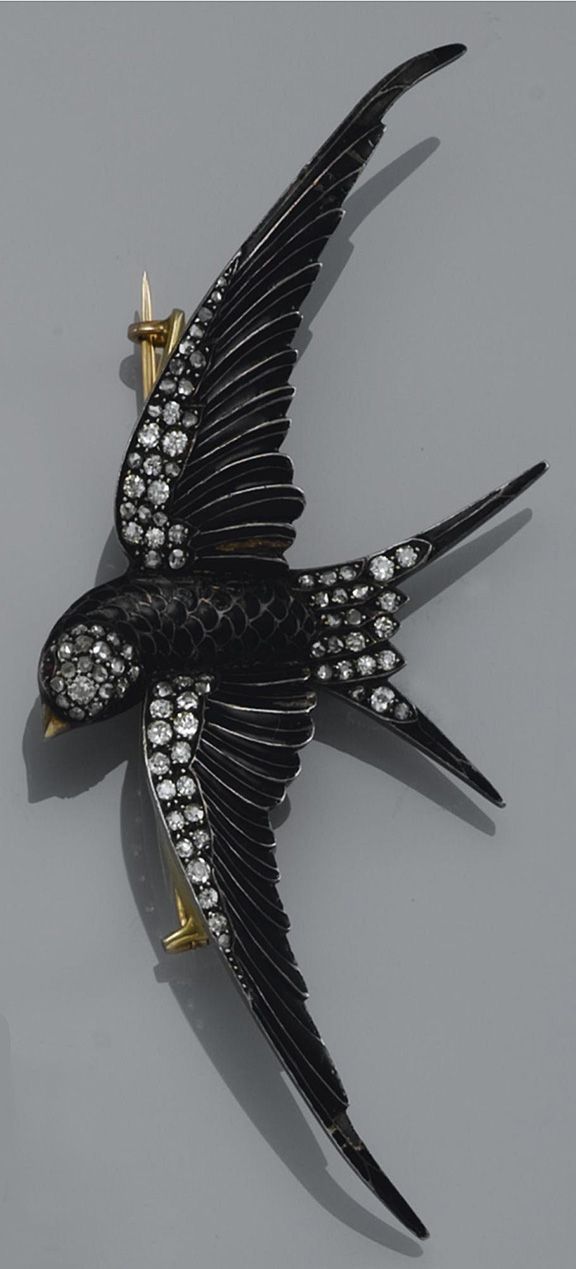 AN ENAMEL AND DIAMOND BROOCH, FRENCH Designed as a swallow in flight, decorated ...