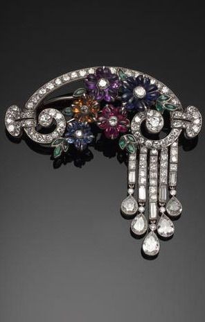 An elegant gem-set flower and diamond brooch, circa 1930, in original brown leat...