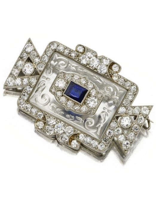 Carved rock crystal, sapphire and diamond brooch, Cartier, circa 1920. The carve...