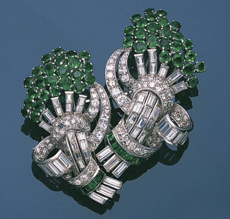 An emerald and diamond double clip brooch, circa 1935  Designed as two stylised ...