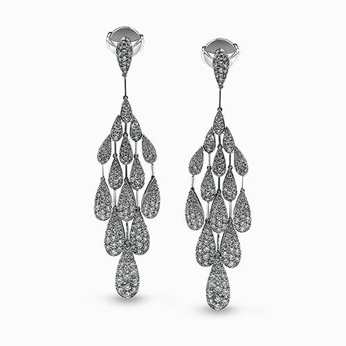 Set in white gold, this dazzling chandelier style contemporary earrings feature ...