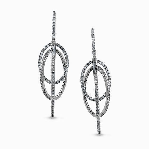 These dramatic white gold contemporary earrings feature a double loop design acc...