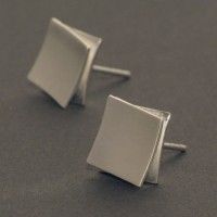 These silver ear studs are modern and functional due to their bright silver lust...