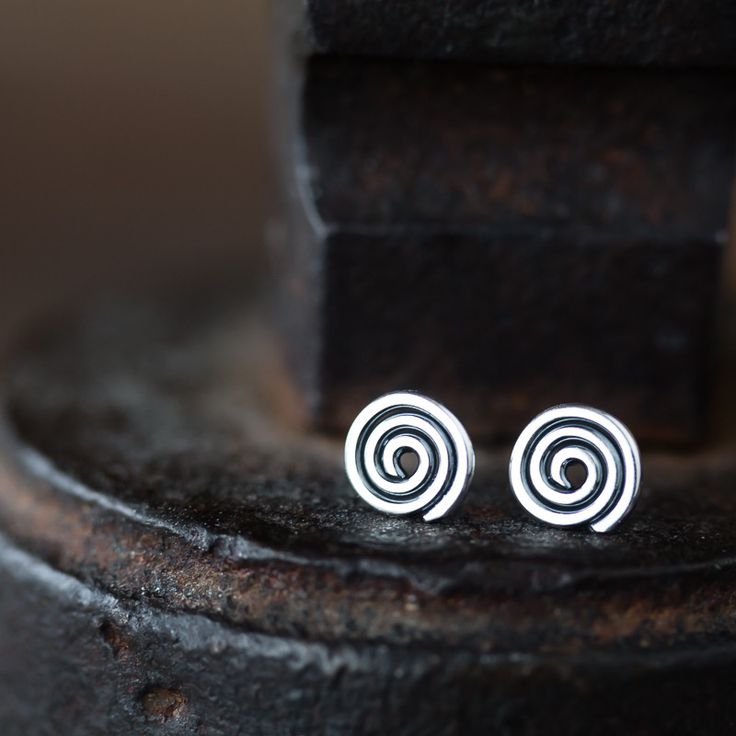 Tiny hammered Celtic spiral studs handcrafted with a great attention to detail a...