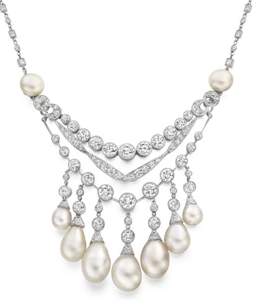 A natural pearl and diamond necklace. The central swag motif variously set throu...