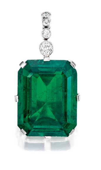 Important Platinum, Emerald and Diamond Pendant:  Suspending an emerald-cut emer...