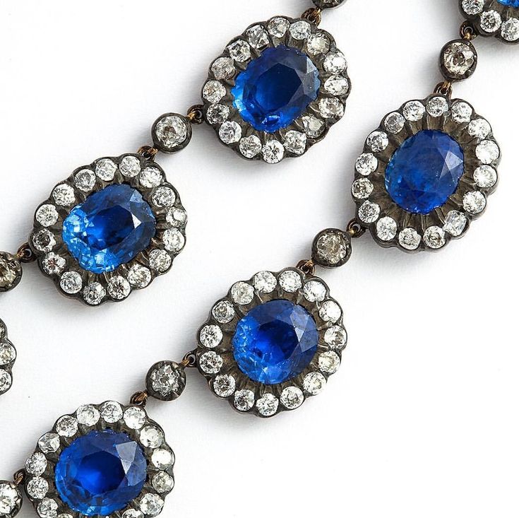 Sapphire and diamond, set à la entourage in siover-topped gold.
