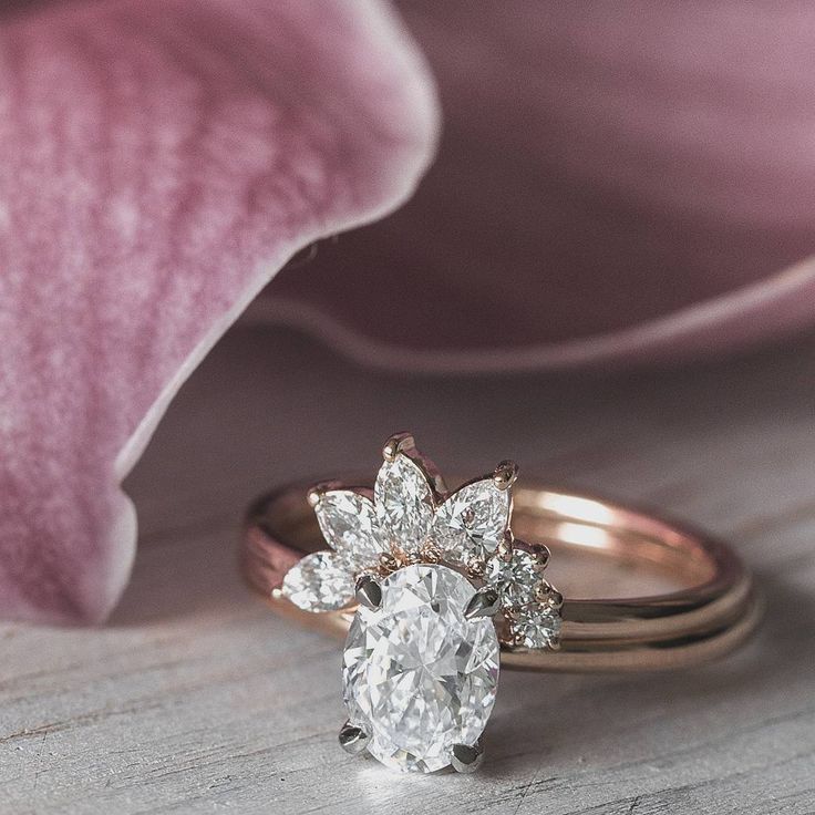 Spray diamond band paired with our classic oval diamond solitaire engagement rin...