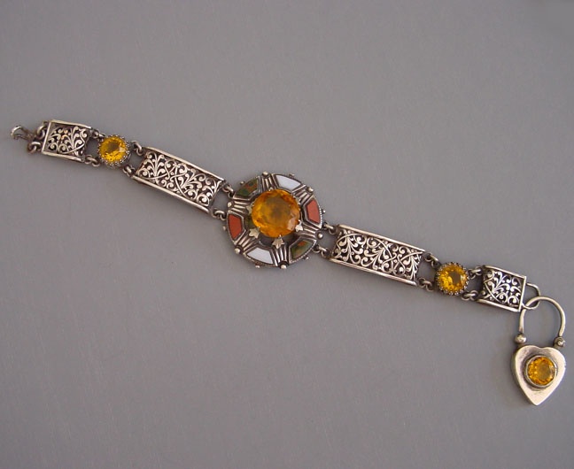 A citrine, silver, and agate bracelet with padlock closure.