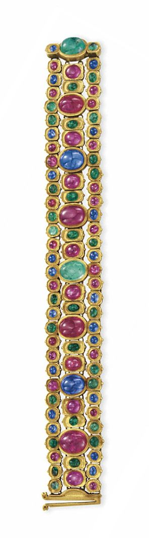 A ruby, sapphire, emerald and gold bracelet. Designed as a series of bezel-set c...