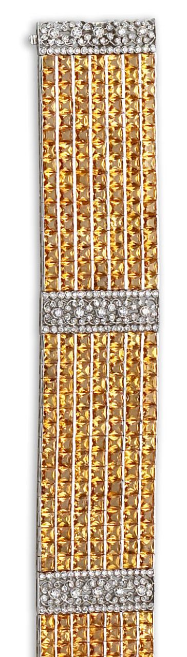 A diamond and yellow sapphire bracelet  the wide bracelet designed as three pane...