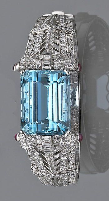 A retro aquamarine and diamond bangle bracelet, circa 1945 the hinged bangle wit...