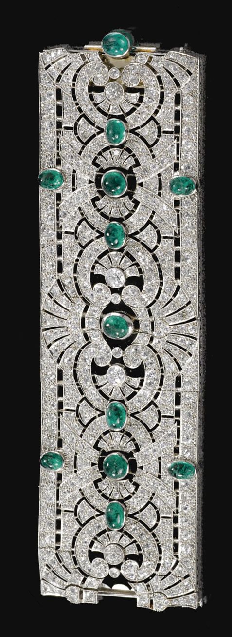 EMERALD AND DIAMOND BRACELET, CIRCA 1925.  Designed as a wide open work band of ...