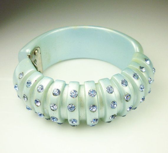 Presented is a fabulous vintage powder blue lucite and rhinestone hinged clamper...