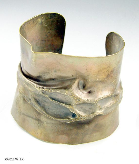 A gorgeous fold-formed cuff in brass, with some chasing.