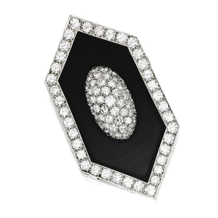 18 KARAT WHITE GOLD, ONYX AND DIAMOND PENDANT-BROOCH. The navette-shaped pendant...