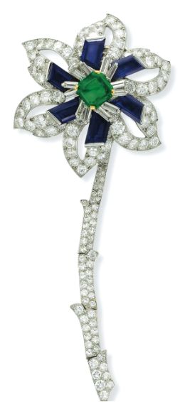 A DIAMOND, EMERALD AND SAPPHIRE FLOWER BROOCH, BY CARTIER Designed as a flower b...