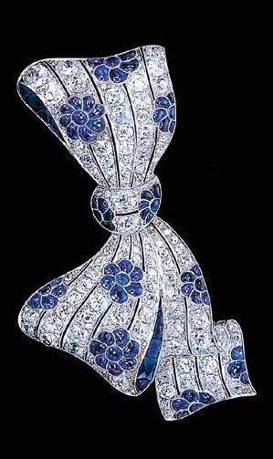 A FINE SAPPHIRE AND DIAMOND BOW BROOCH Designed as diamond openwork lines with c...