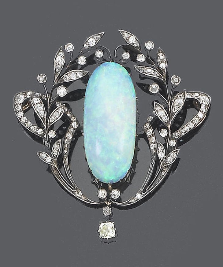 A late 19th century opal and diamond brooch/pendant, circa 1890 The oval cabocho...