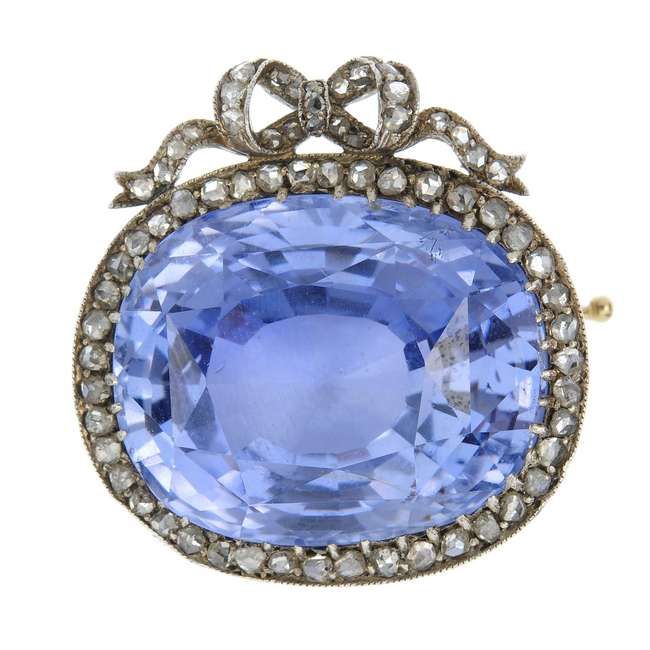 A silver & gold sapphire & diamond brooch, circa 1905. The oval-shape sapphire, ...