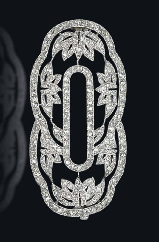 AN ART DECO DIAMOND BROOCH, BY CARTIER. The scalloped oval-shaped openwork panel...