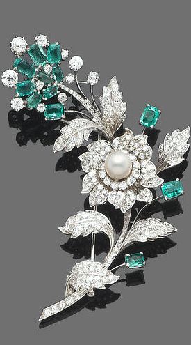 An emerald, cultured pearl and diamond spray brooch The floral spray composed of...