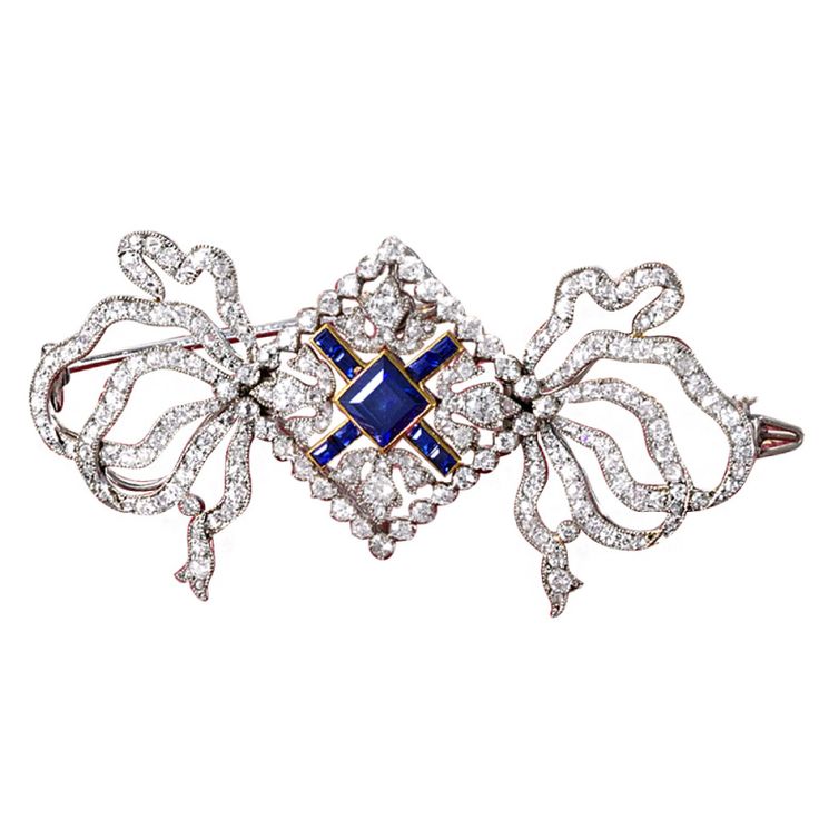 Edwardian diamond and sapphire brooch by Cartier. This charming bow motif brooch...