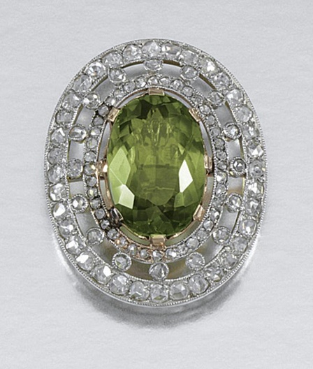 PERIDOT STICK PIN, EARLY 20TH CENTURY.  Set to the centre with an oval peridot, ...