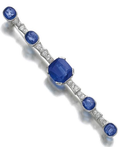 Sapphire and diamond bar brooch, Cartier, 1930s. Set with a cushion-shaped sapph...