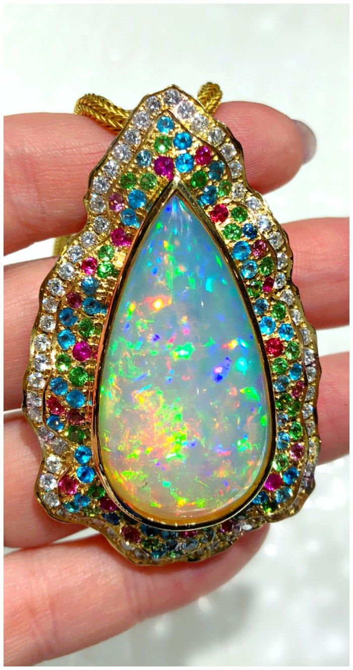 A beautiful necklace by Paula Crevoshay with a 30.64 ct opal, blue zircon, pink ...