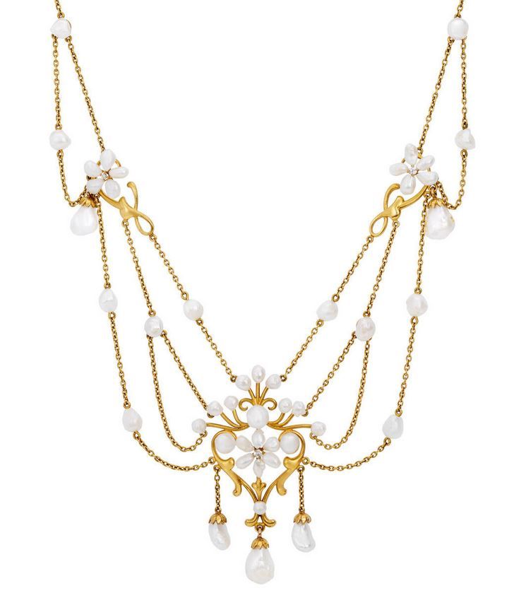 A diamond, pearl and 14 karat yellow gold floral swag necklace, circa 1900.
