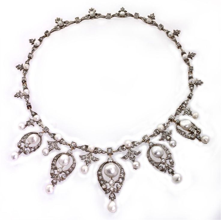 A late Victorian necklace comprising five graduated pearl and diamond drops of a...