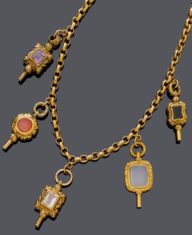 AN ANTIQUE GOLD NECKLACE WITH GEMSTONE KEY PENDANTS, CIRCA 1850. Cable chain sus...