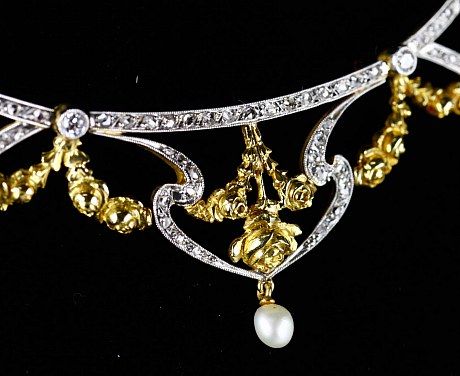 Detail of an art nouveau diamond, pearl and gold necklace.