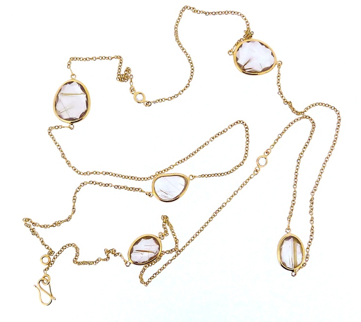 Long bezel-set rutilated quartz, diamond and gold necklace.