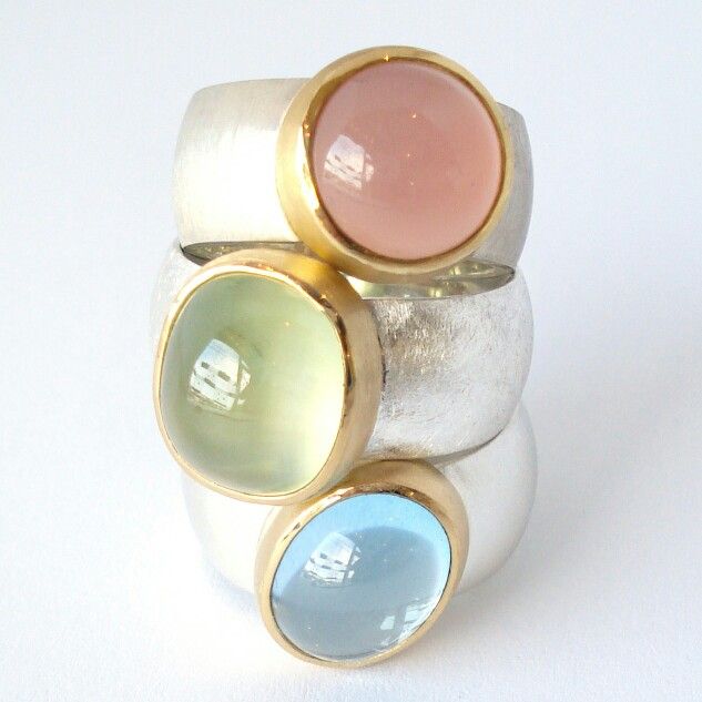 New silver rings with 22 karat gold. The gemstones are a light blue topaz, a pre...