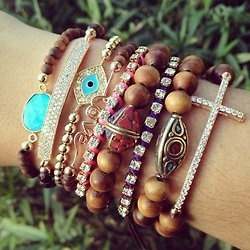 Layer your bracelets of all different styles for an eclectic cool look. To see M...