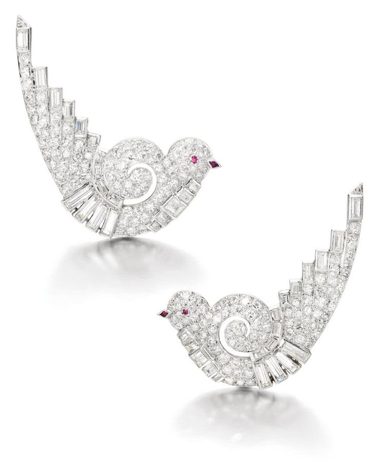 Each designed as a stylized dove set with circular-cut and baguette diamonds, th...