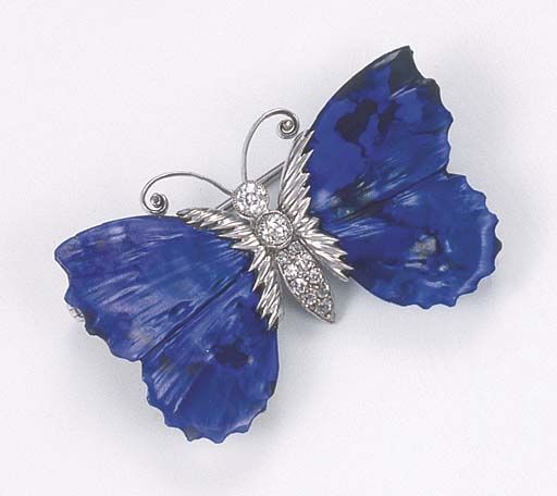 A RARE BLACK OPAL AND DIAMOND BUTTERFLY BROOCH  The carved wings of black opal e...
