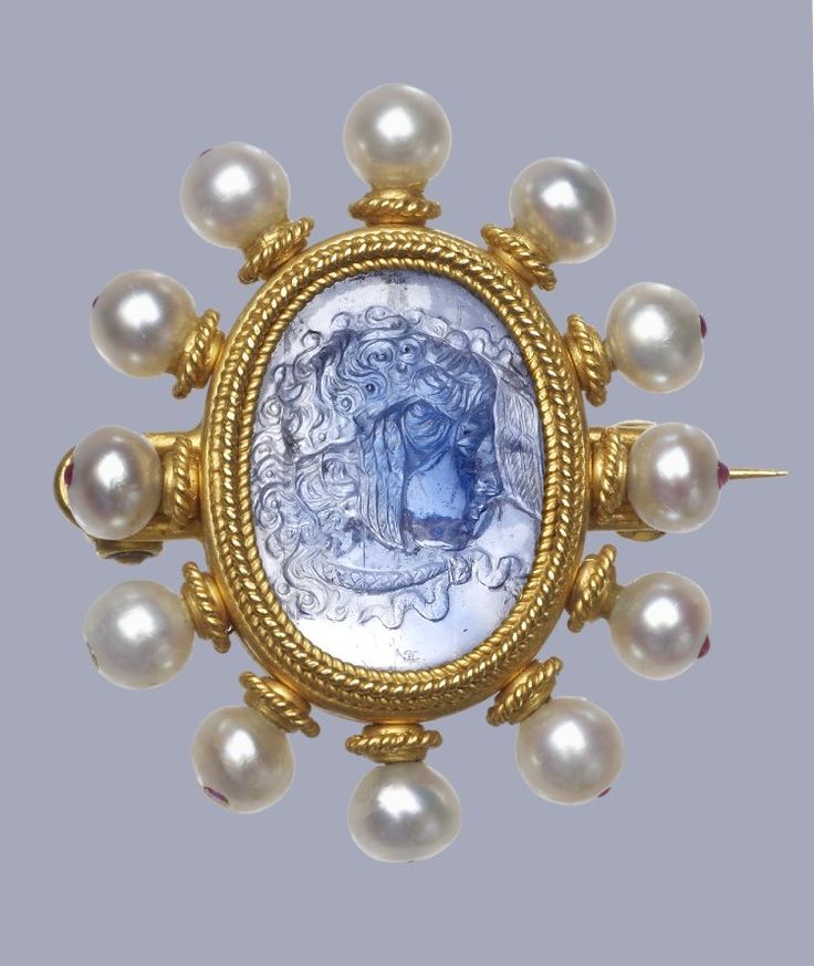 Circa 1870 gold brooch with a central sapphire cameo head of Medusa in a heavy r...