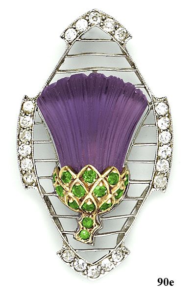 Edwardian thistle brooch, of a single carved amethyst, accented by green garnets...