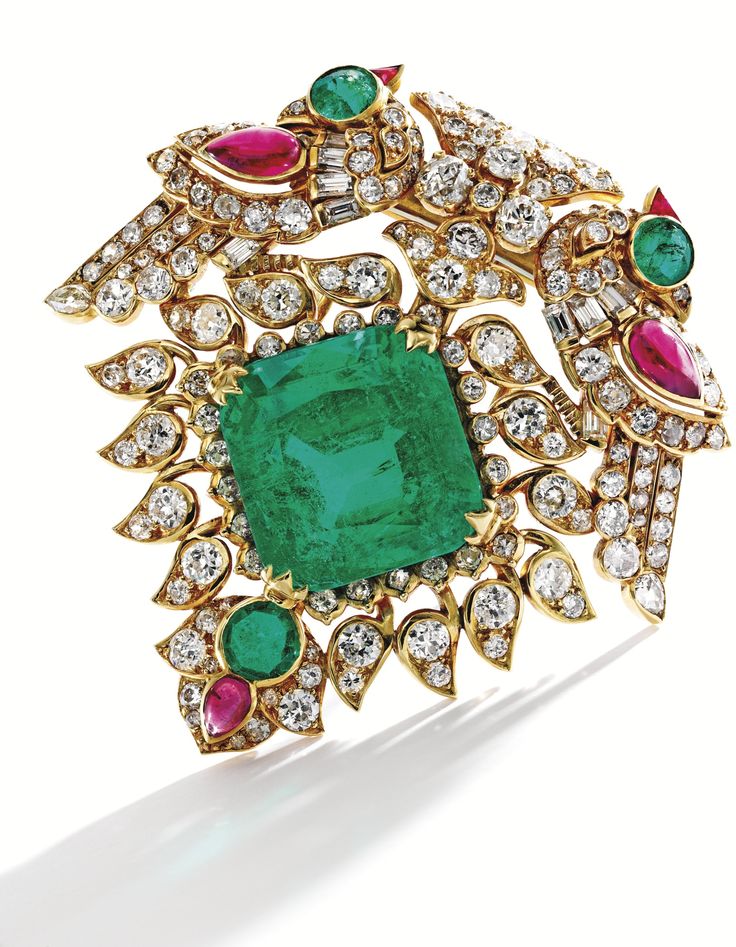 Gold, Emerald, Diamond and Ruby Brooch Of Indian inspiration, centering a cushio...