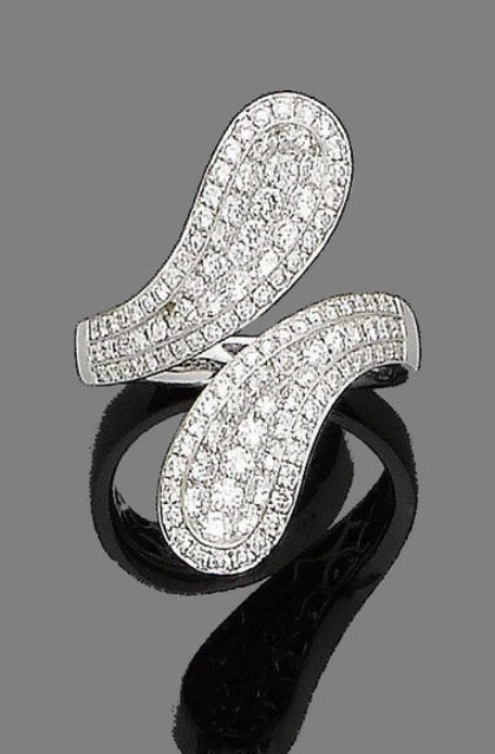 A diamond crossover ring.  Each undulating terminal, pavé-set to the front with...